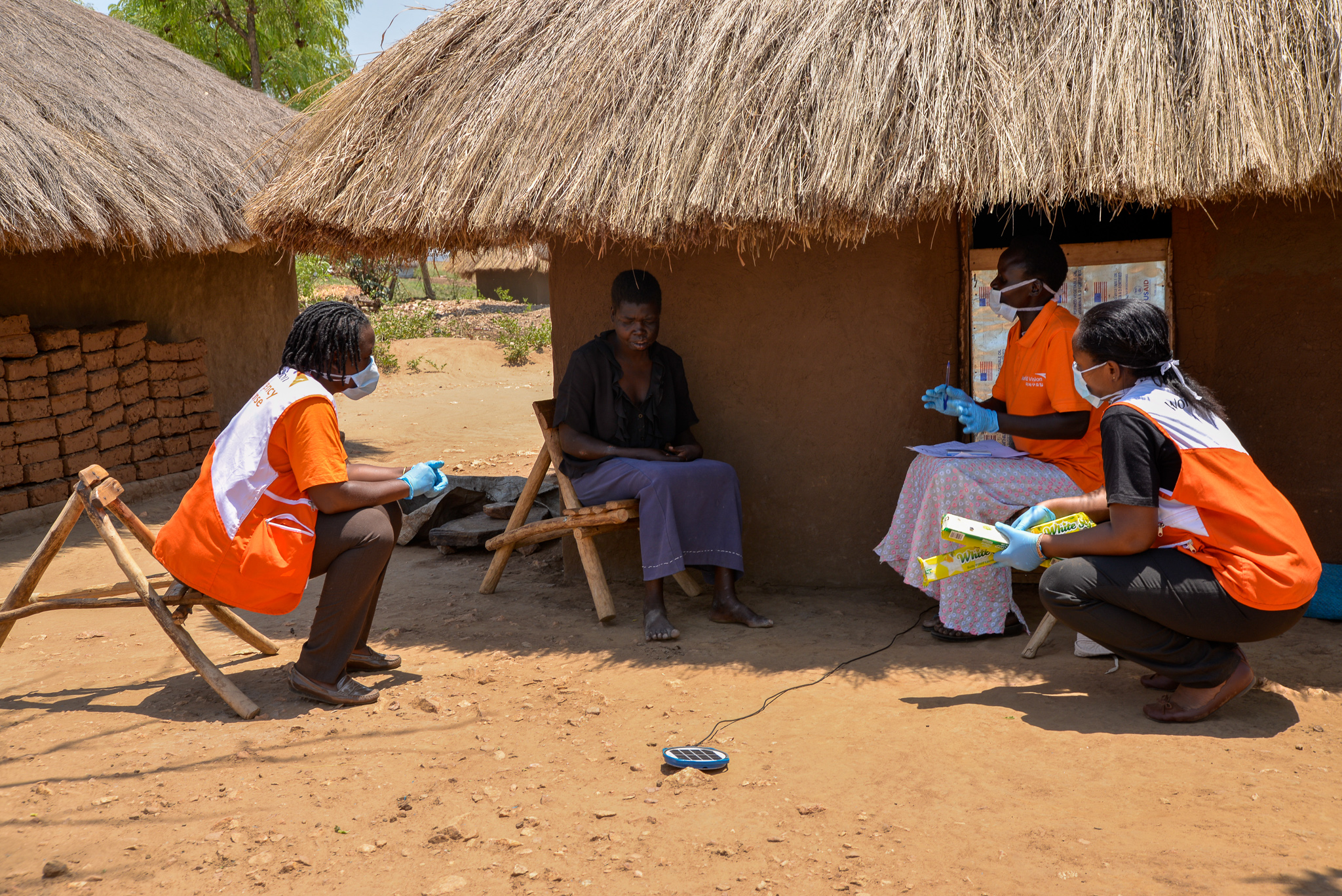 World Vision staff visiting a household in Omugo settlement during soap distribution