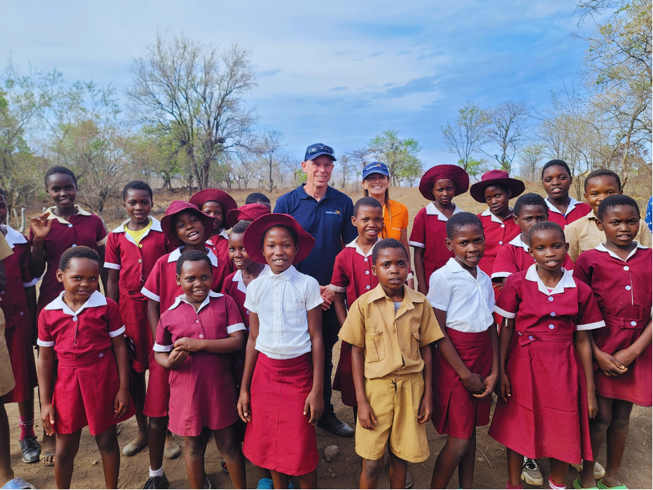 Andrew and Vanessa pose for a group photo with children from Kasibo