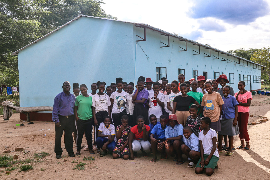 Jabulani Tshuma (school head) posing for a picture with the girls