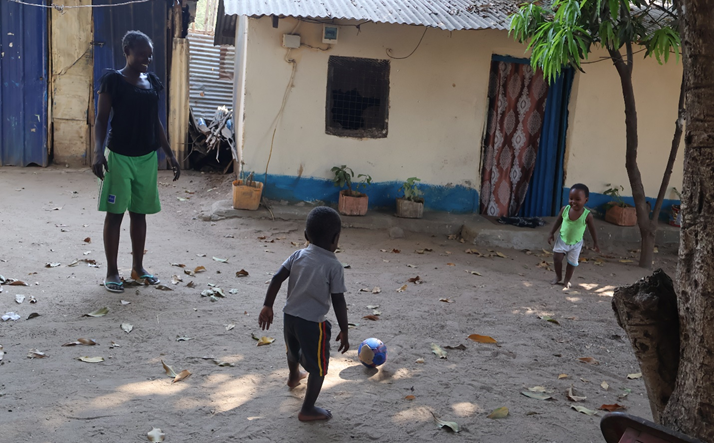 Josephine playing football with her twins  children – Sabrine and Sabrina | Photo by Moses Sakondo | World Vision South Sudan