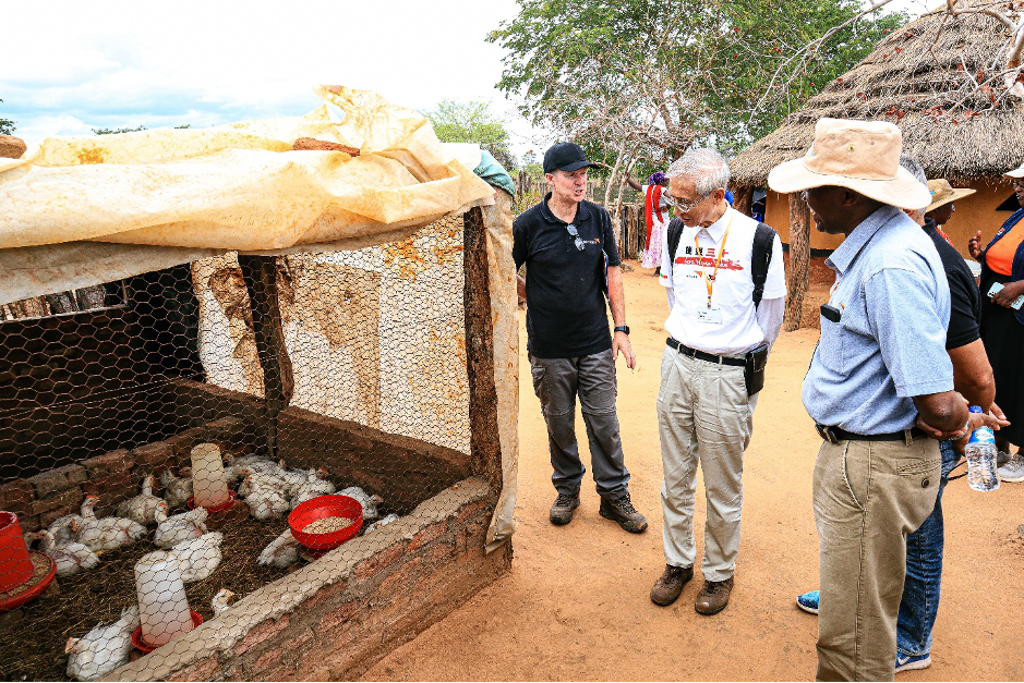 WVI Board members monitoring Rachel Mulewa's chicken project at her household