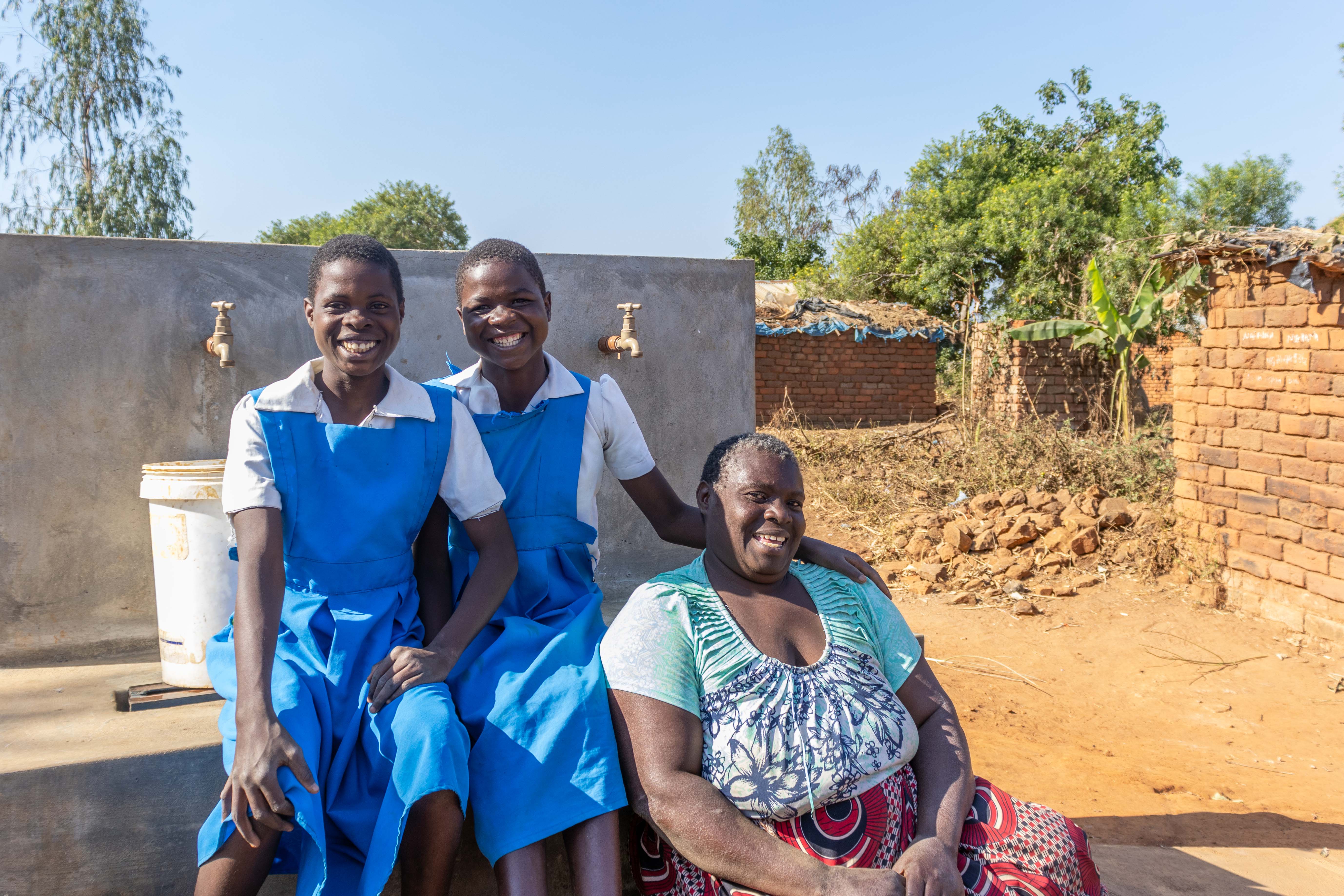 Sellina and her daughters in school uniform