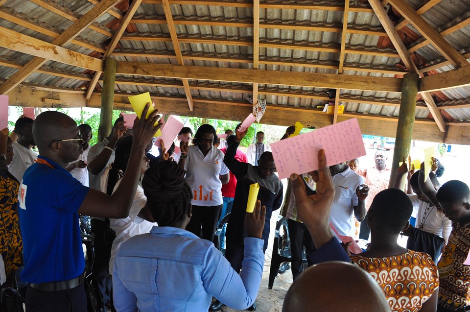 staff and invited guests praying over their letters to vunerable people in other countries