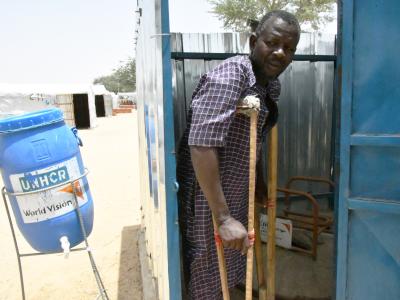 Adamou in the latrine equipped with a chair