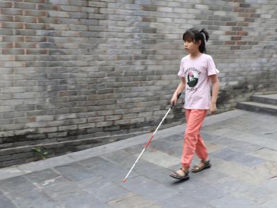Xiaobing can walk unaided now with her skills training.