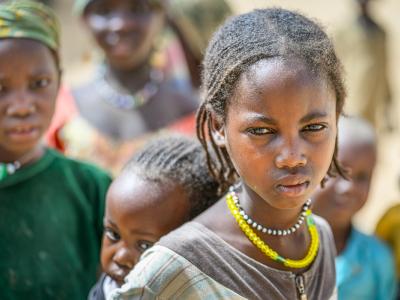 Sudanese refugee girls carrying babies on their backs at the Child Friendly Space in Mile Refugee Camp, Guerera, Chad.