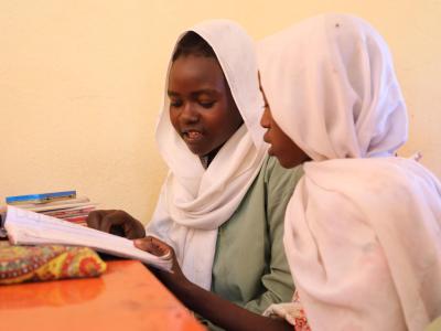 Girls in Sudan reading together 