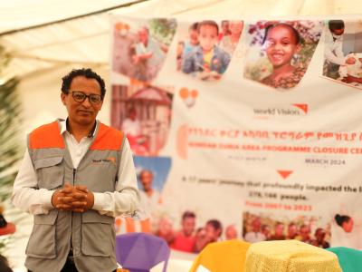 Tewodros Abate standing and smiling to the camera