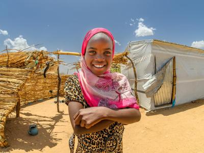 Rachida stands in front of the Gift Catalog shelter