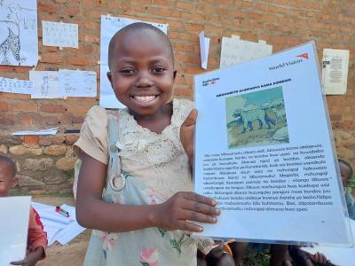 Lesline joyfully showing her book