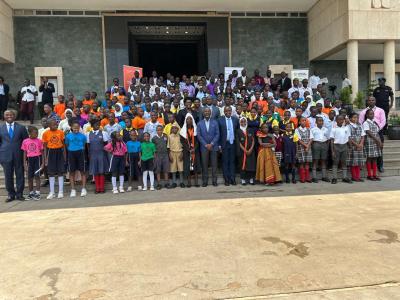 Children with the deputy speaker of parliament and the minister of children and youth affairs in front of the parliament of Uganda