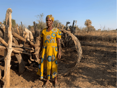 Violet Mudzemba standing besides her cattle kraal