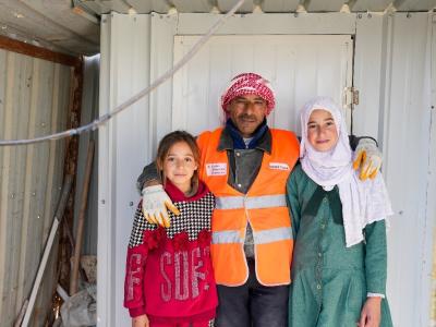 Ismail* with his two daughters next to the private latrine installed