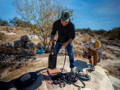 Farmers using a traditional cistern to get water in the West Bank