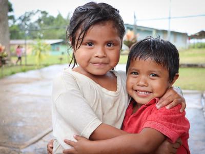 A girl hugging her brother