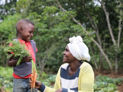 Kifle with her son smiling at her farm