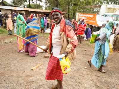 A participant smiles after receiving relief supplies in Gatab Village, Loiyangalani Sub-County. © World Vision Photo/Jared Ontobo