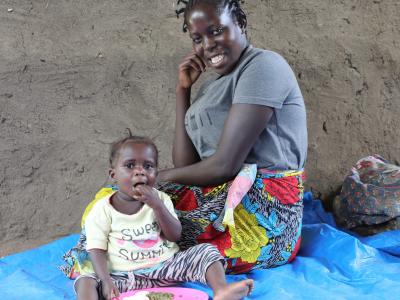 Nadia, once struggling with malnutrition, now enjoys a healthy meal in the company of her mother