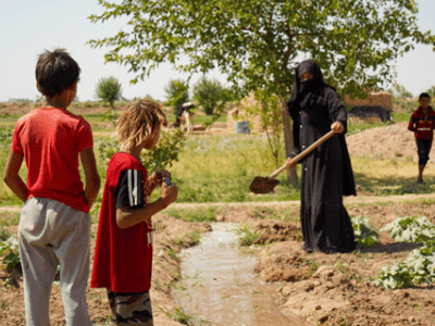 Figure 1: Photo of Handy with her children in her land.