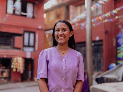 Prekshya gestures as she stands in the middle of a junction in her community.