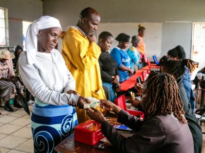 Project participants receiving cash at Domborambwari Primary School in Epworth