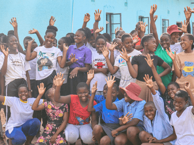 Girls from Guwe High School posing for a picture in front of the boarding house