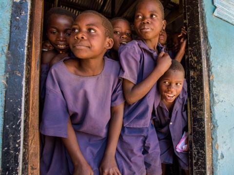 School children waiting and looking out of the doorway