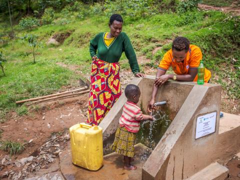 A World Vision employee in Africa showcases a water pump.