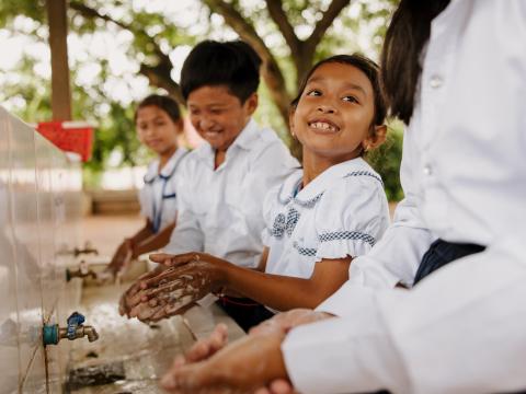 Children in Cambodia wash their hands at school thanks to new handwashing facilities provided by World Vision