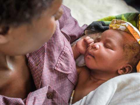 Newborn baby held by mother