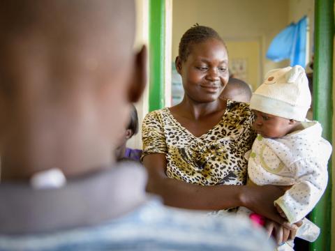 A mother holds her baby at a World Vision facility.