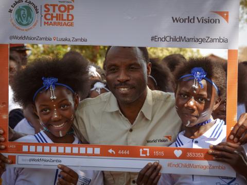 civic leader takes a picture with children at the launch of stop child marriage campaign in Mumbwa (2).jpg