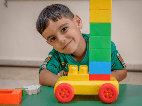 Boy playing with blocks and car