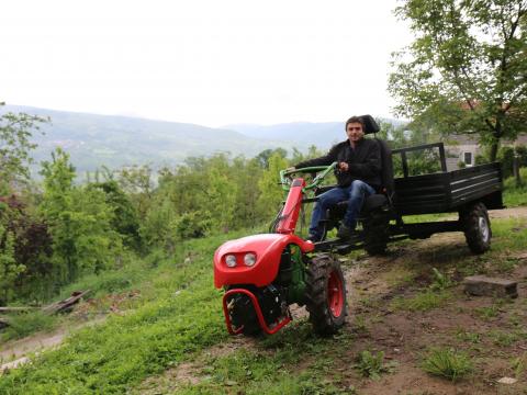 Survivor of a landmine accident, Abid rides the motor cultivator received as a donation trough the „Integrated socio-economic help to the mine victims“ project.