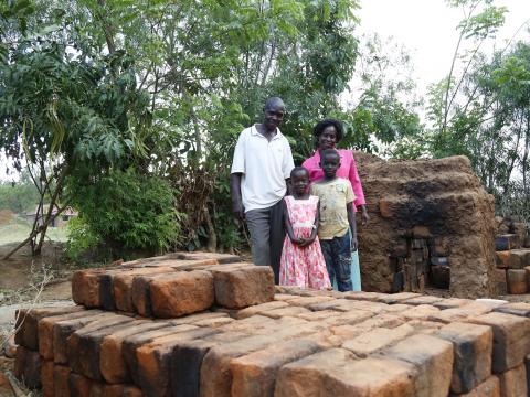 Joseph with his wife Joan and two of their children, Dalmas and Skovia, at their brick making site in their home in Busia, Kenya. ©World Vision/Photo by Susan Otieno.