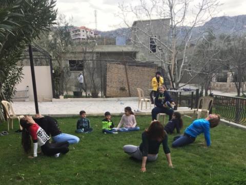 Elise doing Yoga with her family