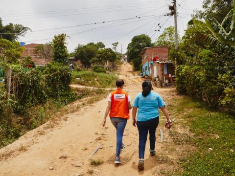 World Vision staff member walks on a dusty road in Colombia