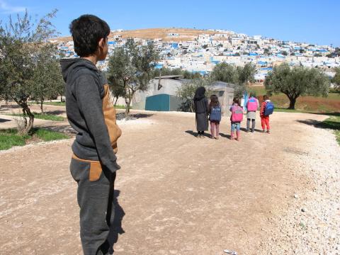 Syrian boy looks over his new home