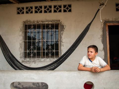 Joshua, young sponsored child in Ecuador outside his home.