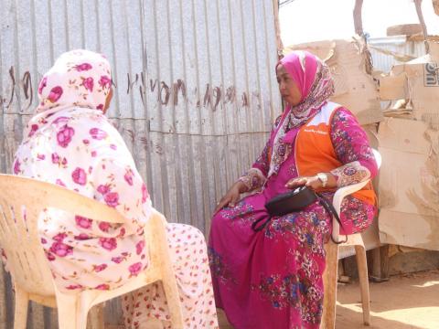 World Vision staff counselling a woman