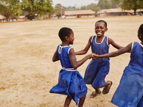 Girls playing holding hands in Ghana