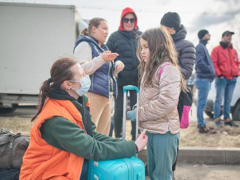 Ukrainian refugee girl with World Vision staff