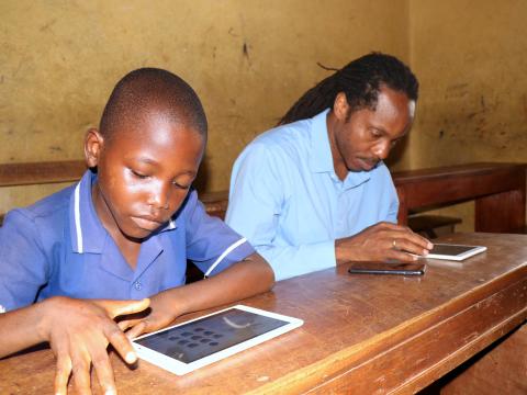 Minister of Education observing the learning using one of the Tab