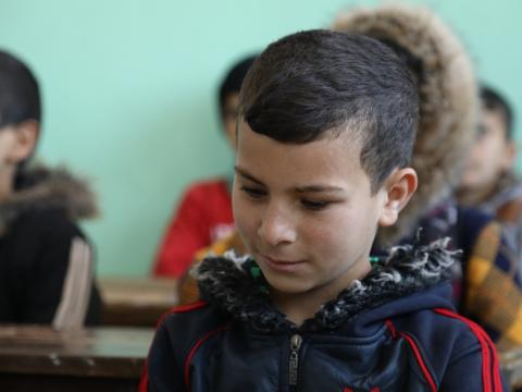 Amir at school in Syria refugee camp