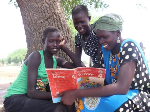 Children revising with the help of a community tutor