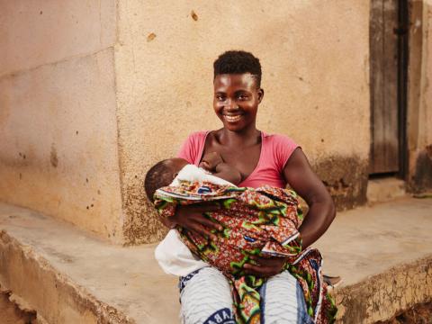 Elizabeth and her child attending a training session with World Vision Ghana