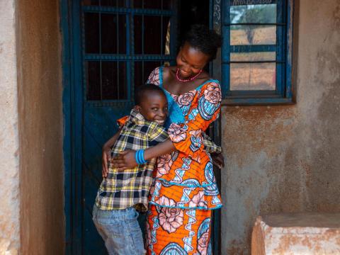 Empowered mother stands with her son