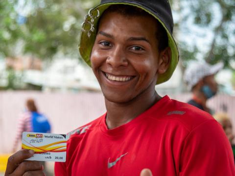 Peru Ecuador man cash card hat smiling 