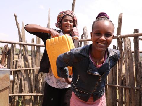 Girl in Ethiopia collects water from a water point near her home