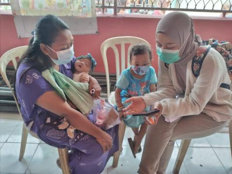 Staff in Indonesia work with parents on changing behaviours around sanitation